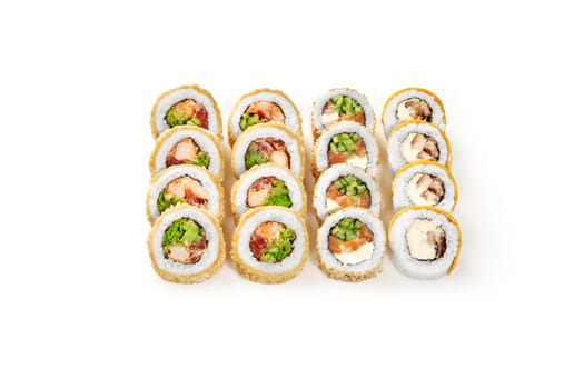 Crispy tempura with crab and tobiko, sesame covered salmon rolls and unagi uramaki topped with sweet mango neatly arranged isolated on white background. Japanese culinary traditions