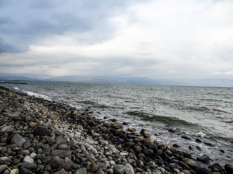 Rocky shore of the sea or lake.The sea of Galilee also called Lake Tiberias or Kinneret, Israel. High quality photo