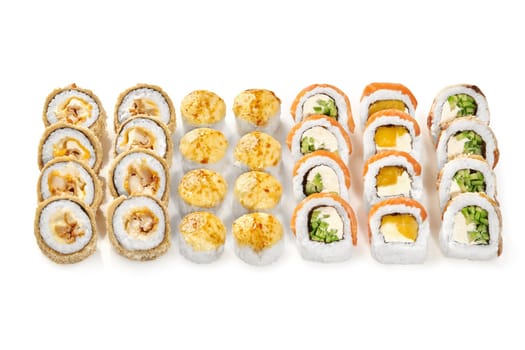 Set for company of baked roll with creamy melted cheese, crispy tempura roll with chicken, classic uramaki with salmon, eel and mango arranged on white background. Japanese fusion cuisine