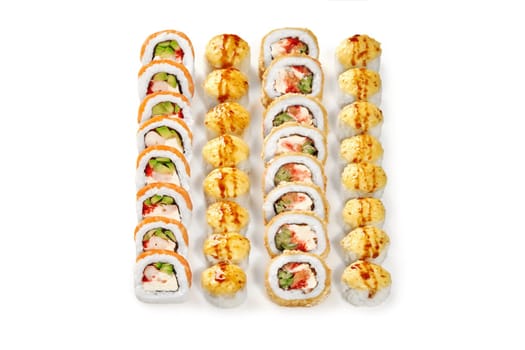 Set of baked rolls with golden cheese caps drizzled with unagi sauce and uramaki with salmon, shrimp, tobiko and fresh vegetables, arranged on white background, ready to enjoy. Japanese cuisine