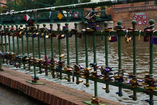 Wroclaw, Poland - August 4, 2023: A bridge adorned with numerous padlocks symbolizing love and commitment.