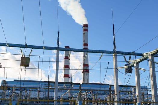 A power plant releasing thick smoke into the air, emphasizing industrial pollution and environmental impact.