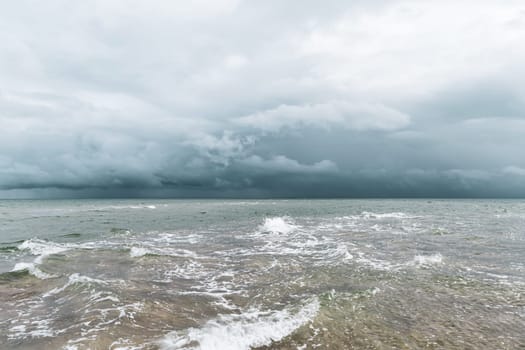 Dramatic seascape in dark colors. Dark sky with clouds over the stormy sea. High quality photo