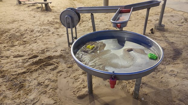 playground, sand, water, metal circle for playing. High quality photo