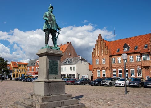 Koge, Denmark - May 1, 2023. City square with a monument to the Danish king Frederick VII. Old houses in Koge Town Centre. High quality photo