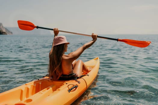 Kayak sea woman. Happy attractive woman with long hair in red swimsuit, swimming on kayak. Summer holiday vacation and travel concept