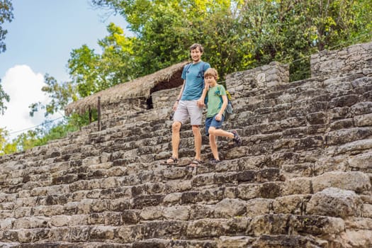 Dad and son tourists at Coba, Mexico. Ancient mayan city in Mexico. Coba is an archaeological area and a famous landmark of Yucatan Peninsula. Cloudy sky over a pyramid in Mexico.