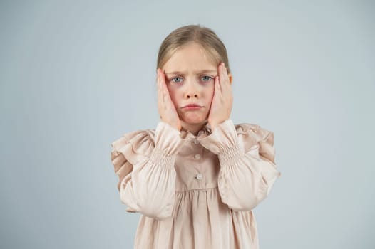 Portrait of a dissatisfied Caucasian girl on a white background