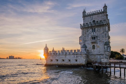 Belem Tower or Tower of St Vincent - famous tourist landmark of Lisboa and tourism attraction - on the bank of the Tagus River Tejo on sunset. Lisbon, Portugal
