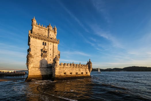 Belem Tower or Tower of St Vincent - famous tourist landmark of Lisboa and tourism attraction - on the bank of the Tagus River Tejo on sunset. Lisbon, Portugal