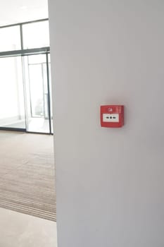 Red fire alarm button on wall