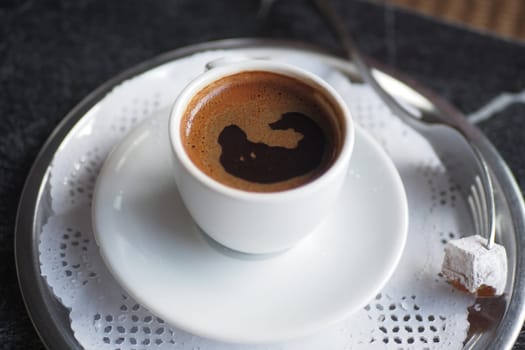 a cup of turkish coffee on table .