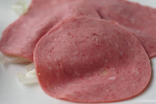 Salami smoked sausage slices on white background,