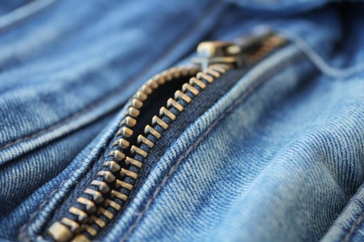 Closeup of metal zipper on denim jeans,