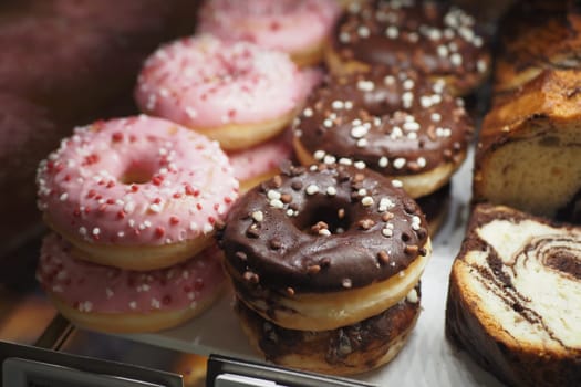 chocolate donuts display for sale at local store ,