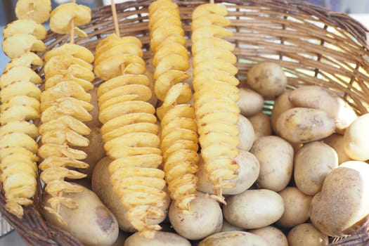 fried chips potatoes frying in boiling hot oil in a deep fryer