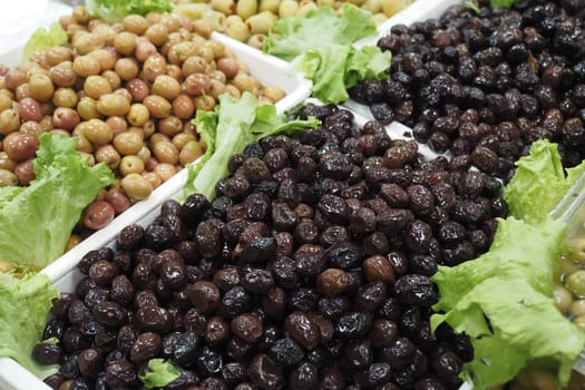 Buckets of olives for sale street food market.