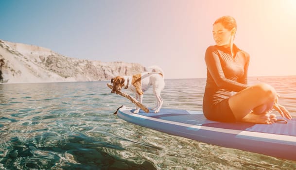 Sea woman sup. A happy positive woman in hat with family relaxing in sea, aerial back view of family on SUP board floating on calm water. Active lifestyle at sea. Summer vacation. Slow motion