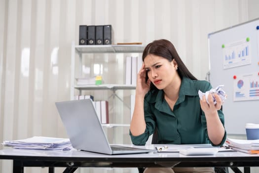 Young businesswoman has problems with her work in the office Feeling stressed and unhappy, showing a serious expression.