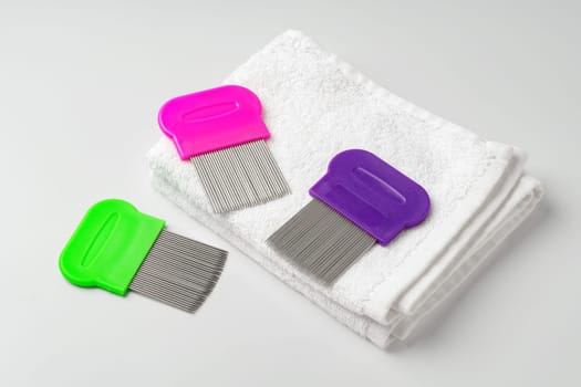Anti lice combs and towel on white background close up