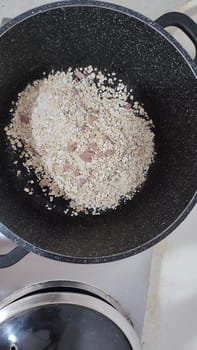 white cereal in a black pan, food. High quality photo