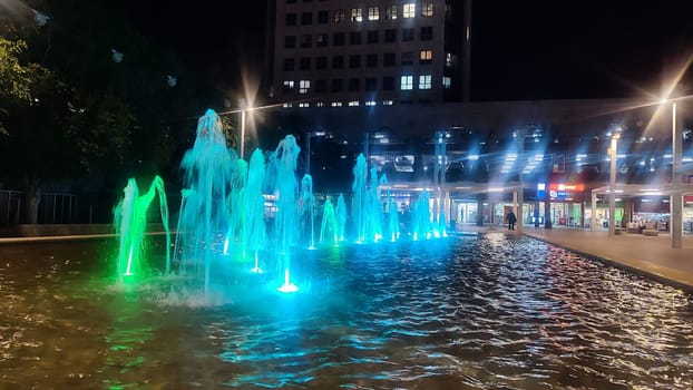fountain at night in the city, blue water color. High quality photo