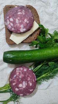 dry smoked sausage, sandwich with butter, green fresh cucumber vegetable, parsley food lunch dinner cooking, breakfast. High quality photo