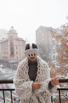 An enchanting woman in VR glasses gazes at the winter cityscape around her. High quality photo