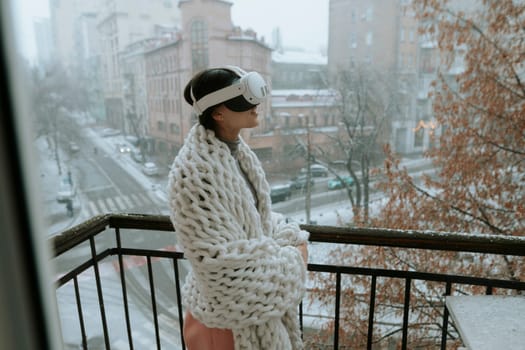 A captivating lady in VR glasses takes in the beauty of the winter city around her. High quality photo