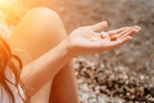 Woman eating milky almond nuts. A young caucasian woman choping fresh green almond after morning fitness yoga near sea. Only hands are visibly. Healthy vegan food. Slow motion. Close up