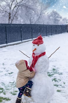 Children make a snowman in winter. Selective focus. Kid.