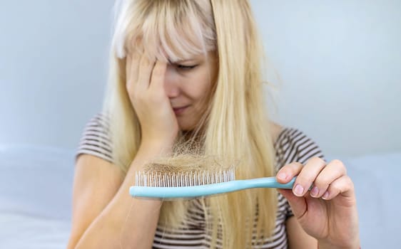 The woman hair is falling out. Selective focus. People.