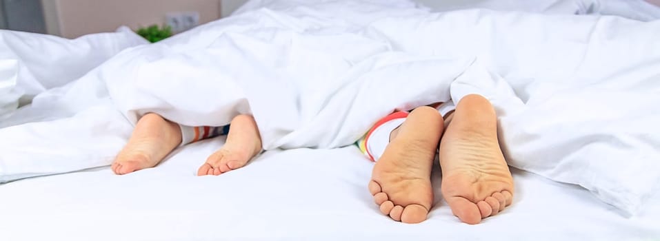 Feet of children in bed. Selective focus. Kids.
