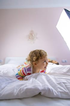 Children play jumping in bed. Selective focus. Kid.