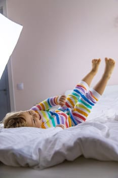 Children play jumping in bed. Selective focus. Kid.