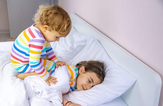 Children play jumping in bed. Selective focus. Kid.