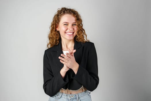 Young Woman With Curly Hair Portrait against gray background in studio