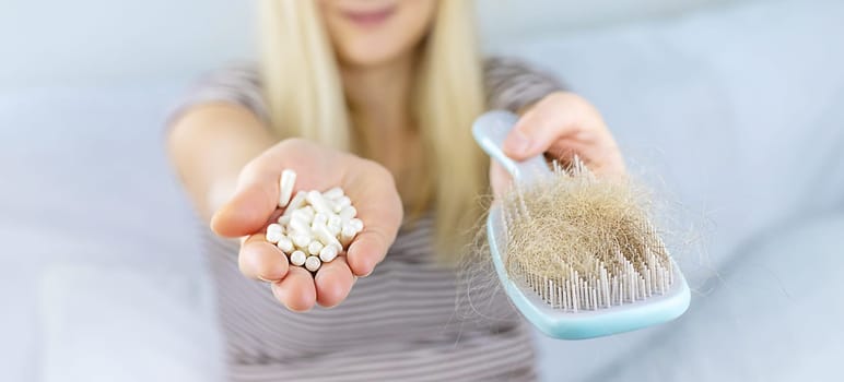 A woman's hair falls out vitamins. Selective focus. People.