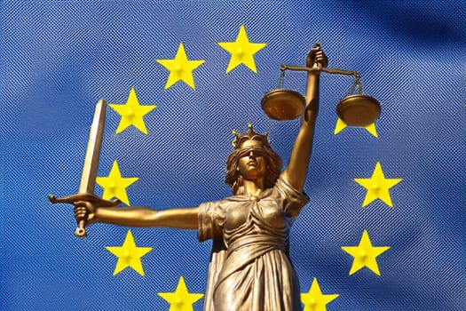 The Statue of Justice, Goddess of Justice in front of the EU flag.