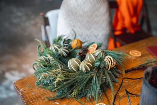 A lovely young lady captivated by a holiday decoration-making masterclass. High quality photo