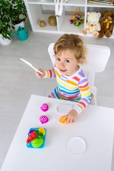 Child plays kitchen and food toys. Selective focus. Kid.