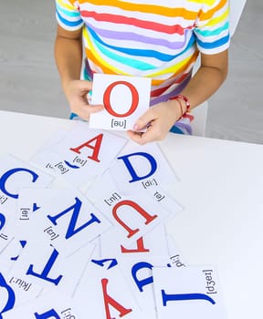 The child learns English letters. Selective focus. Kid.