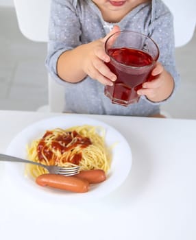 The child eats spaghetti lunch. Selective focus. Food.