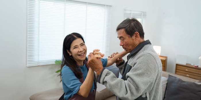 Happy Senior Couple Dancing at Home in a Bright Living Room. Activity Senior concept