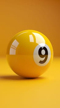 A yellow pool ball with the number 9 on it rests on a yellow surface, creating a vibrant contrast. The circular shape and bold font make it visually appealing for macro photography or art purposes