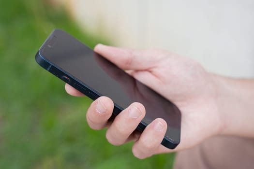 man hands typing on phone browsing mobile phone on social media