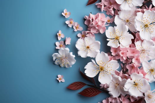 Mother's Day: Beautiful cherry blossom flowers on blue background, flat lay. Space for text