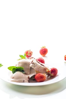 fresh organic cottage cheese with strawberries and ice cream in a plate isolated on white background .