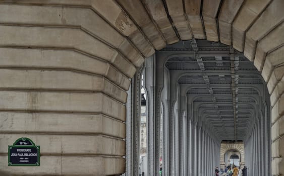 France, Paris - Jan 04, 2024 - Horizontal perspective view of Metal columns of elevated subway at Passy viaduct, Architectural structure of the famous Pont de Bir Hakeim bridge in Paris. Space for text, Selective focus.