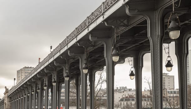 France, Paris - Jan 04, 2024 - Nice view of Pont de Bir Hakeim bridge in Paris. Perspective view of Metal columns and Art Deco street lights of elevated subway at Passy viaduct, Space for text, Selective focus.